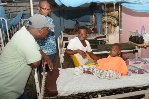 Founder (in cap), visiting a patient after a successful surgery